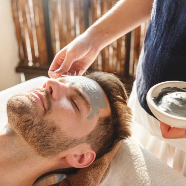man-getting-a-mud-mask-at-a-spa