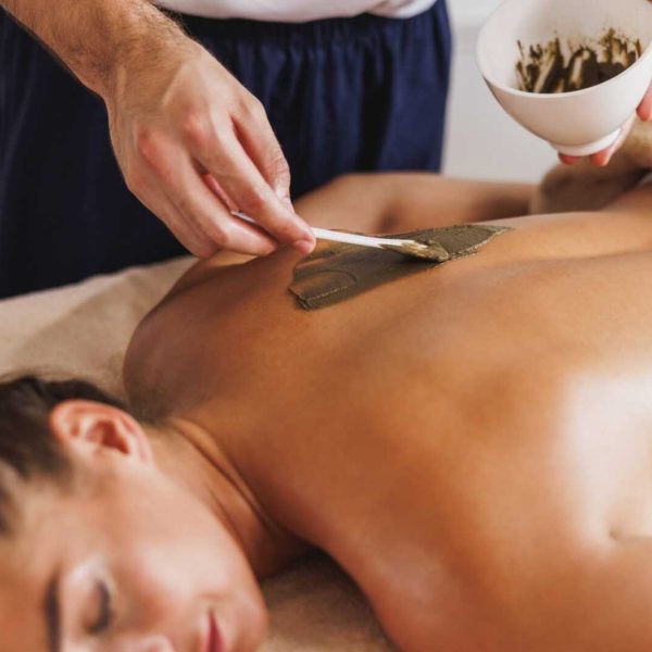 woman-enjoying-seaweed-mud-massage-in-spa-centre