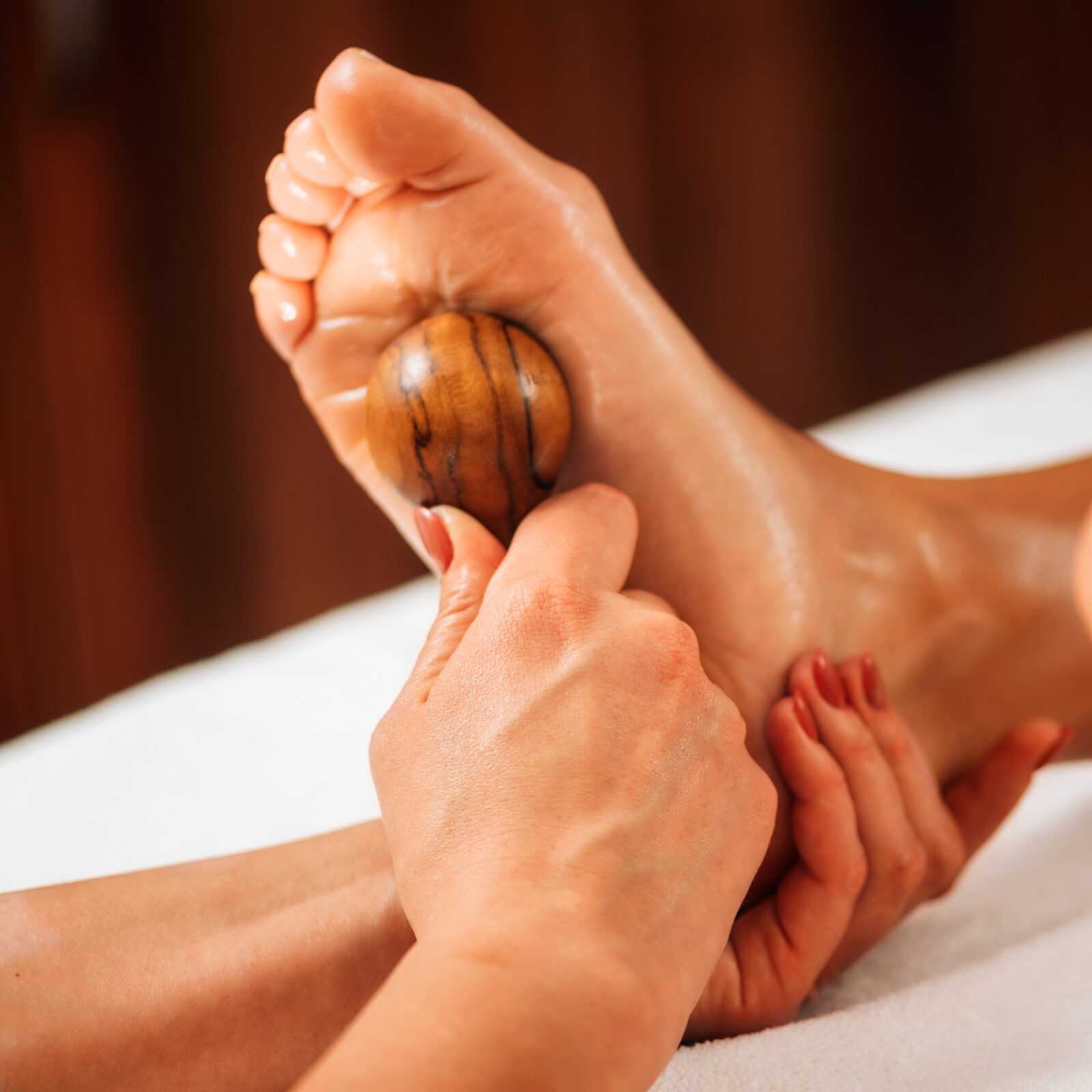 reflexology-foot-massage-with-wooden-massage-tool- reflexology-foot-massage-with-wooden-massage-tool-