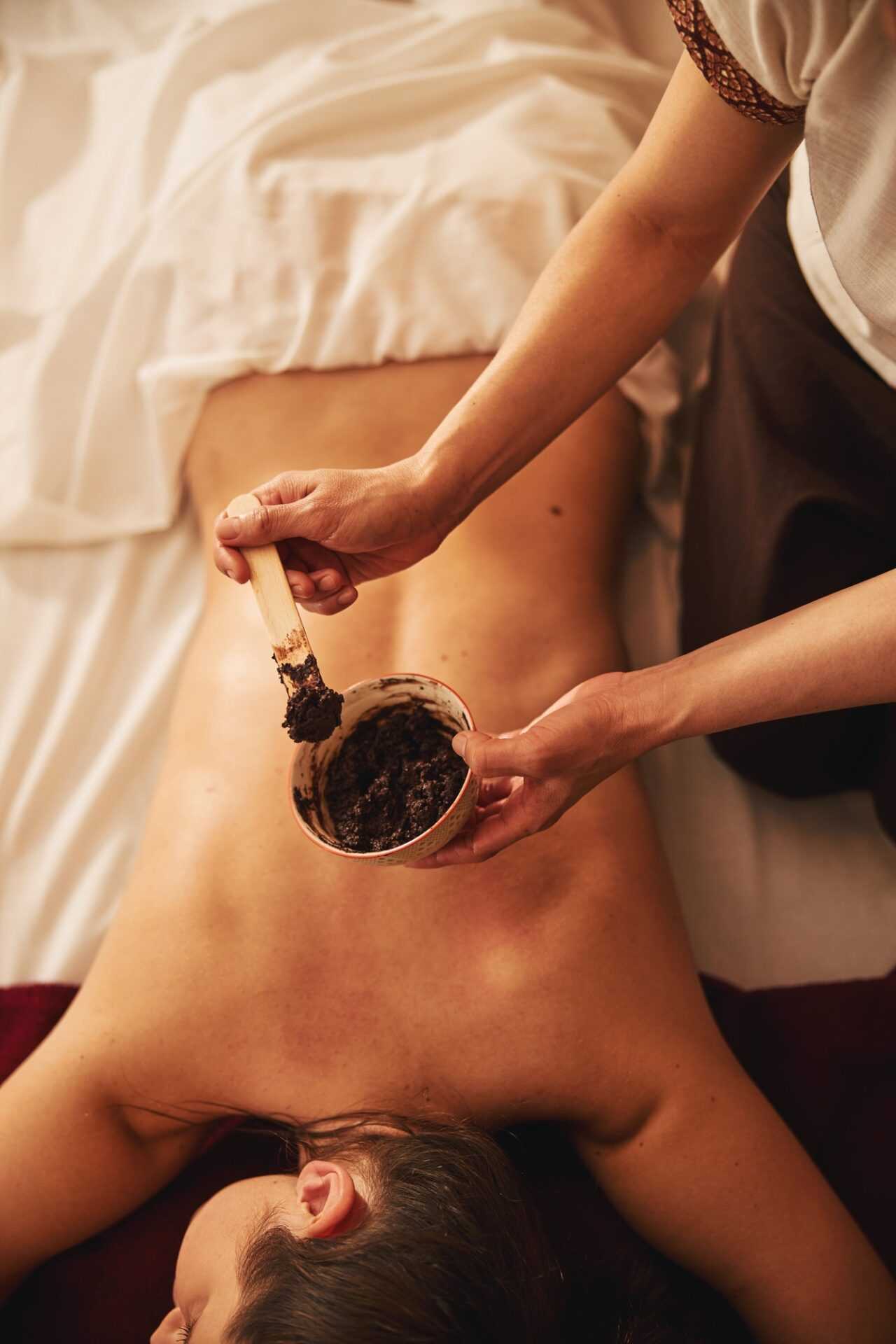 therapeutic-mud-applied-to-visitor-back-in-spa-centre therapeutic-mud-applied-to-visitor-back-in-spa-centre